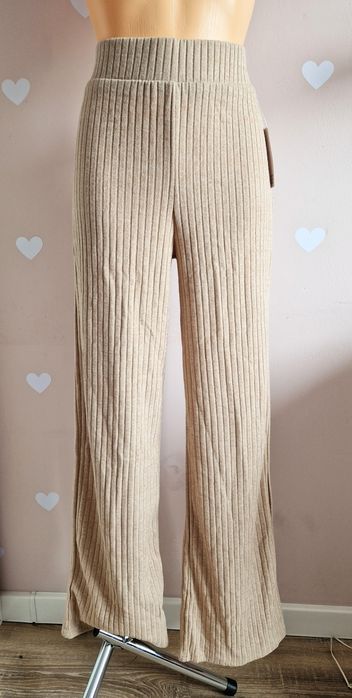 Spodnie materiałowe beżowe rozkloszowane szerokie dzwony prążkowane bu