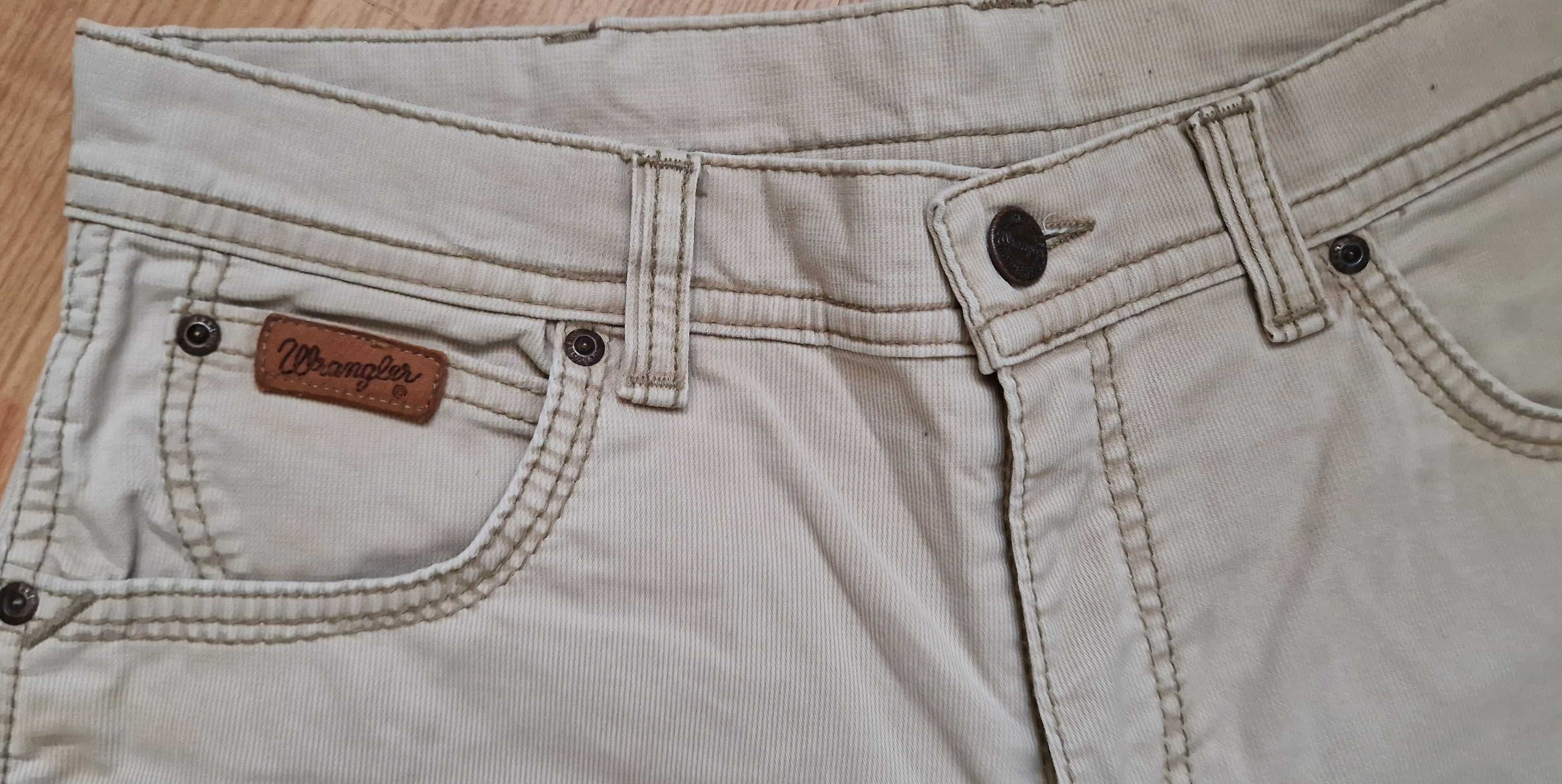 Beżowe Spodnie męskie jeans Wrangler Texas Stretch W34L34
