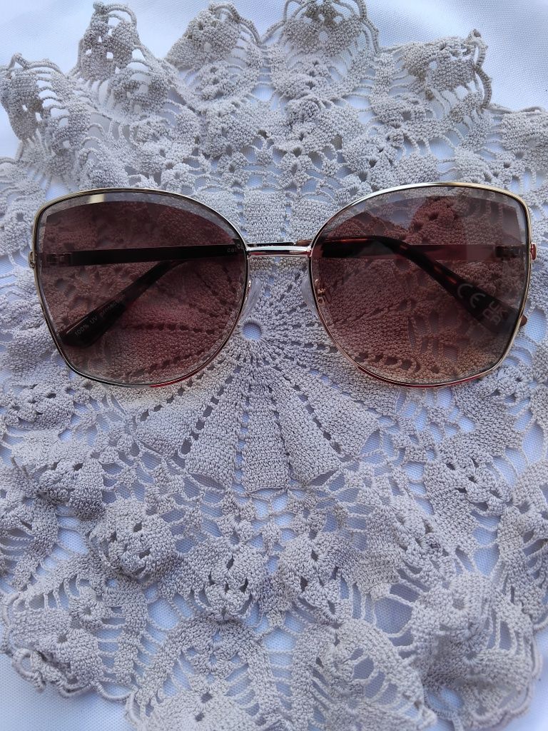 Óculis de sol com armação dourada e lentes marrom-Seaside