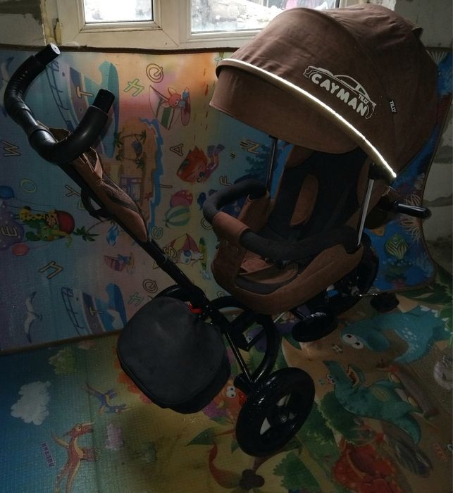 Продам детский музыкальный  велосипед-коляска Cayman.