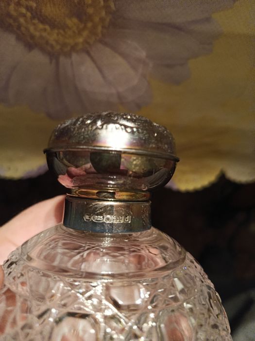 Флакон для духов с серебряной крышкой.