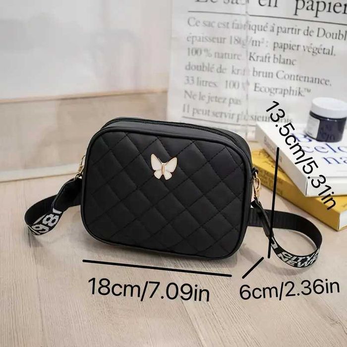 Сумка через плече, зручна з метеликом. Ремішок з написами та без