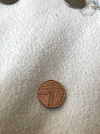 Moeda de One Penny de Elisabeth II de 2016 e moeda de 25 PTAS de 1937 da Repubica Francesa