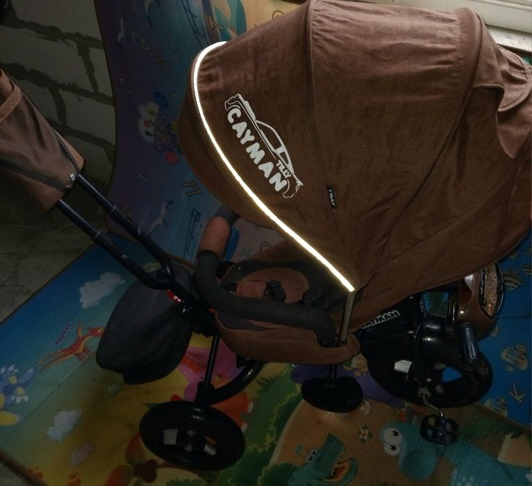 Продам детский музыкальный  велосипед-коляска Cayman.