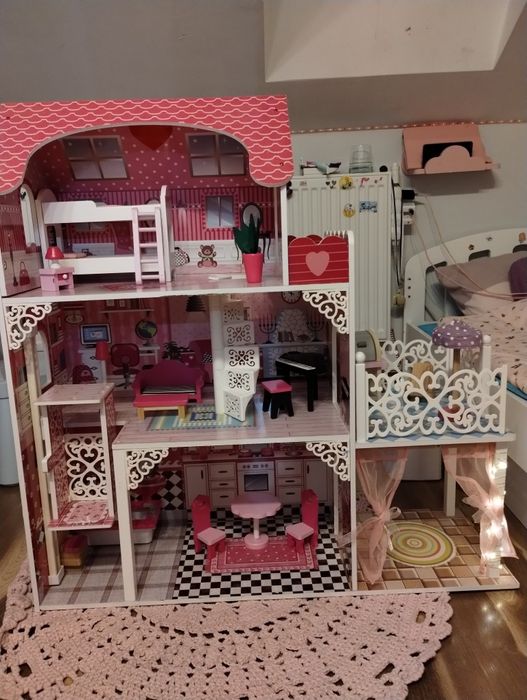Drewniany domek dla lalek z mebelkami i światełkami