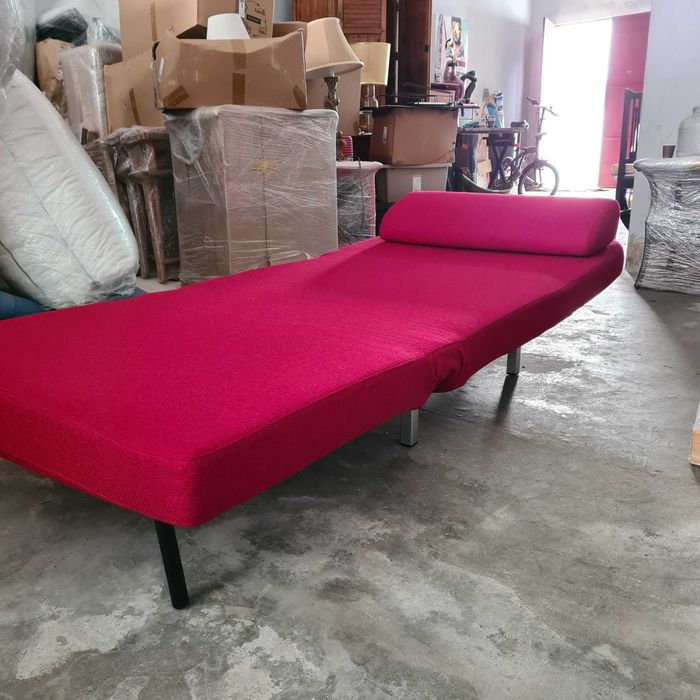 Red Sofa chair that reclines and can turn into a bed for a futon.