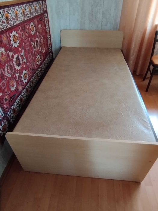 drewniane łóżko z materacem