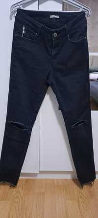 Granatowe  spodnie jeansowe z dziurami  Orsay r 38