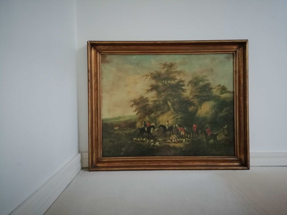 Estampa colorida com moldura dourada representando caçada