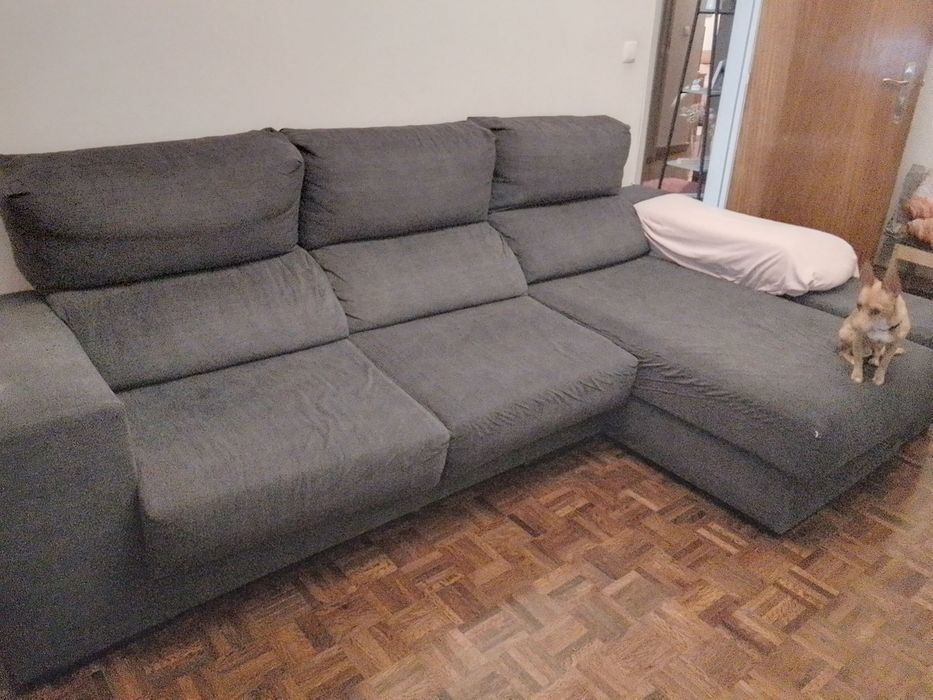 Sofá com chaise long e assentos deslizantes.
