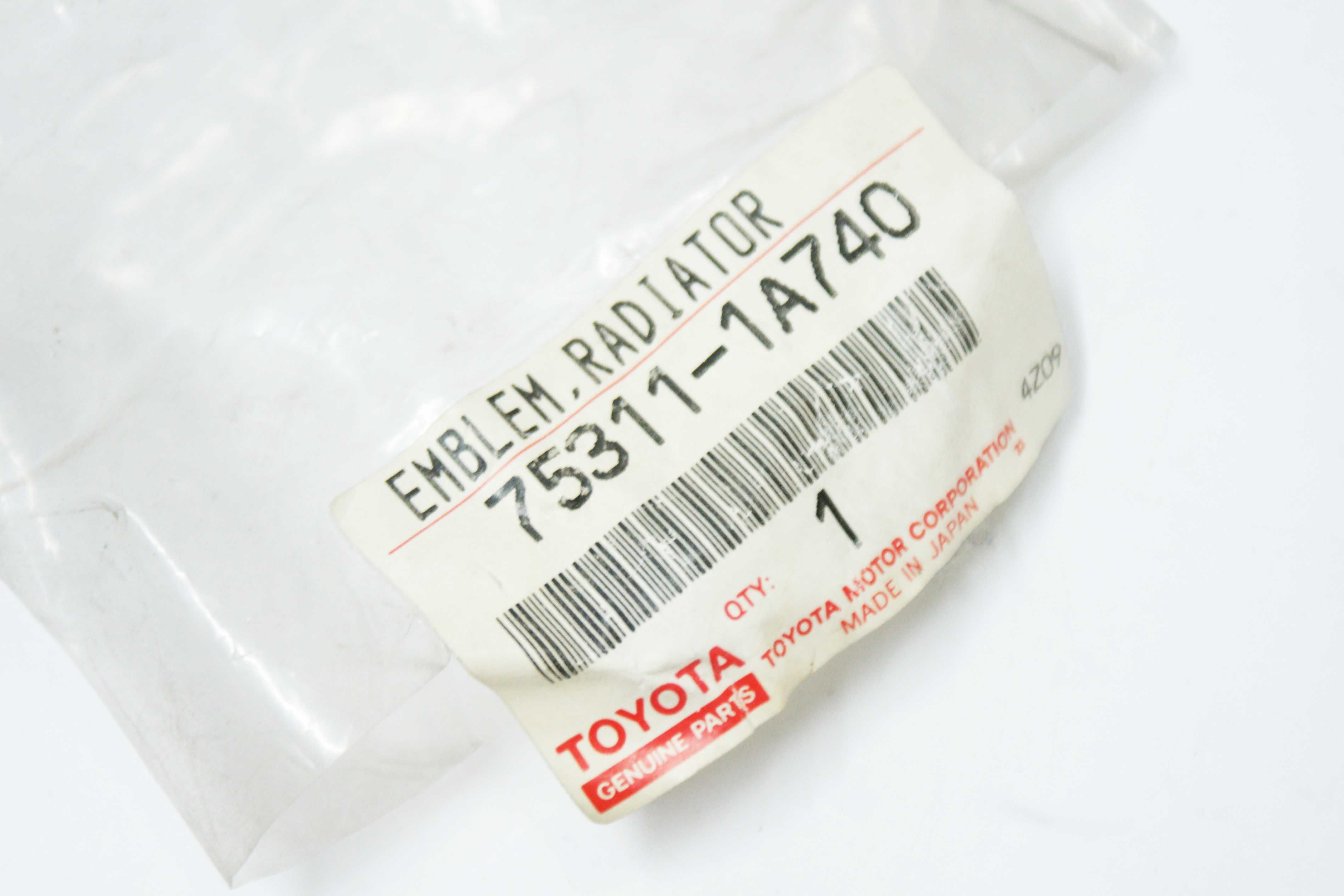 Emblemat logo znaczek grilla Toyota Corolla AE100 AE101 NOWY oryginał