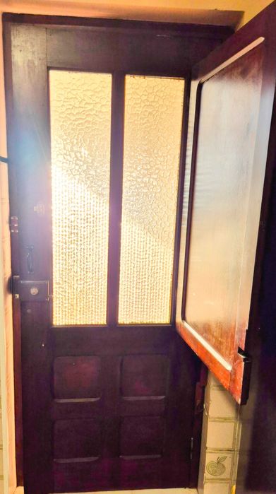 Duas portas antigas em madeira maciça, uma com vidro texturado