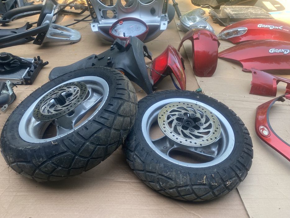 Kymco Grandink 125 owiewka licznik lampa koło zacisk amortyzator bak