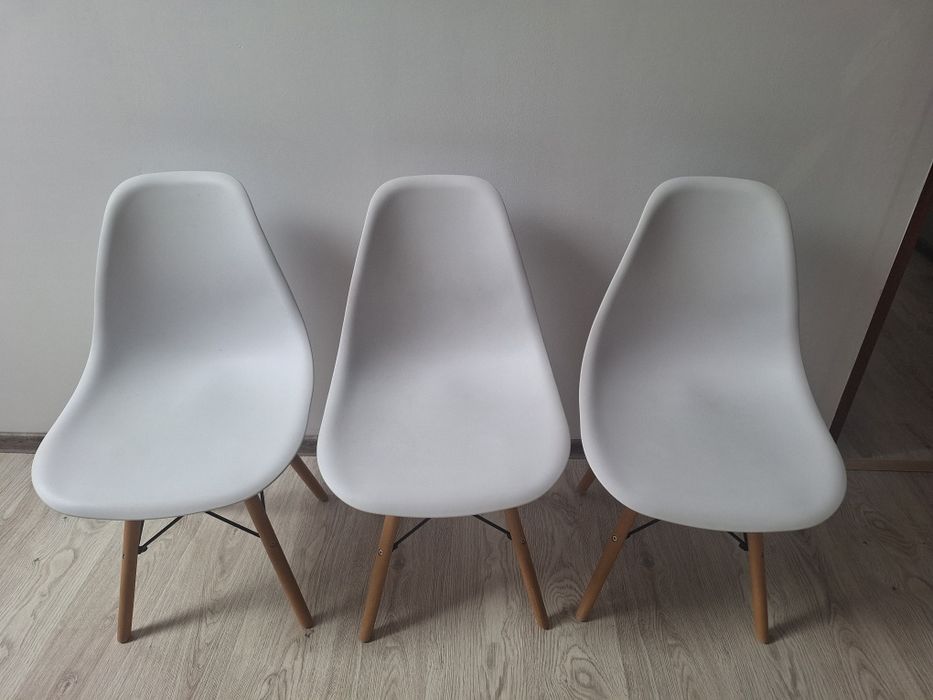 Białe krzesła na drewnianych nogach