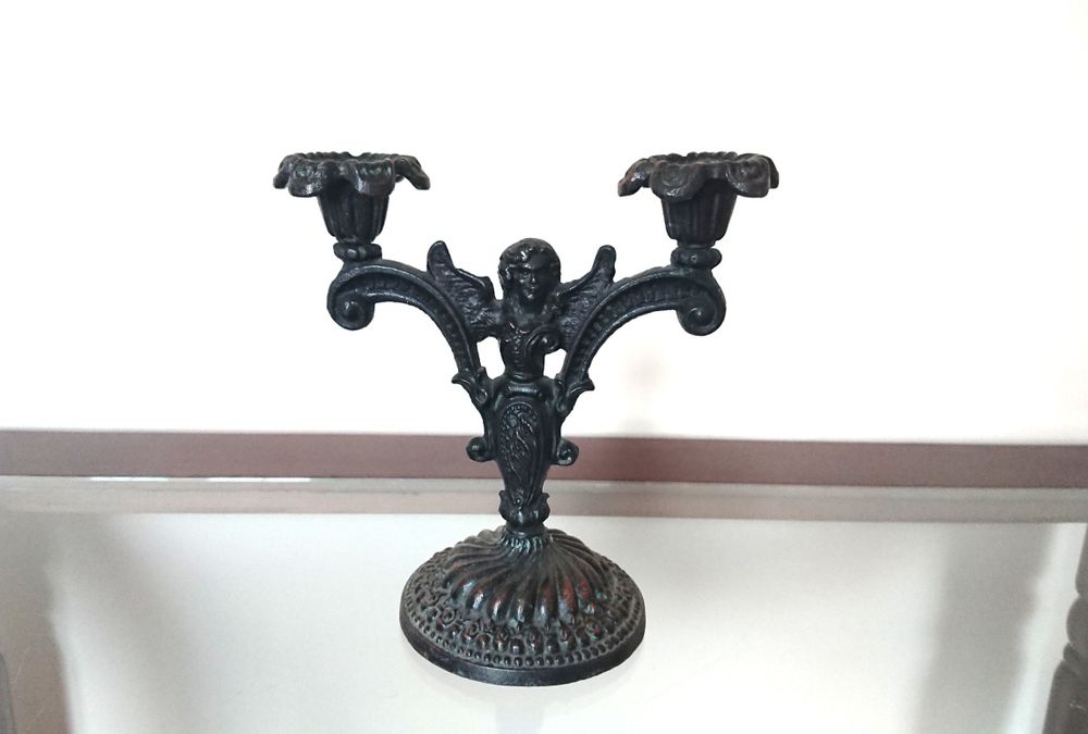 Подсвечник на две свечи украшенный фигуркой ангела.