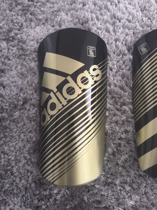 Caneleiras Adidas pretas e douradas