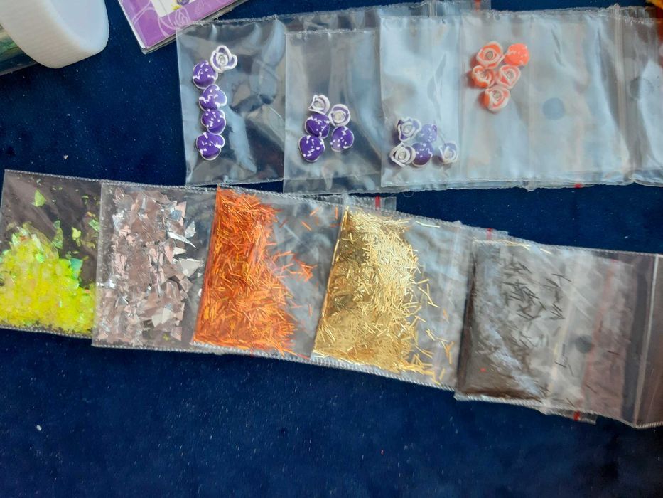Zestaw: ozdoby, brokat, naklejki na paznokcie, frez kamienny, wzornik