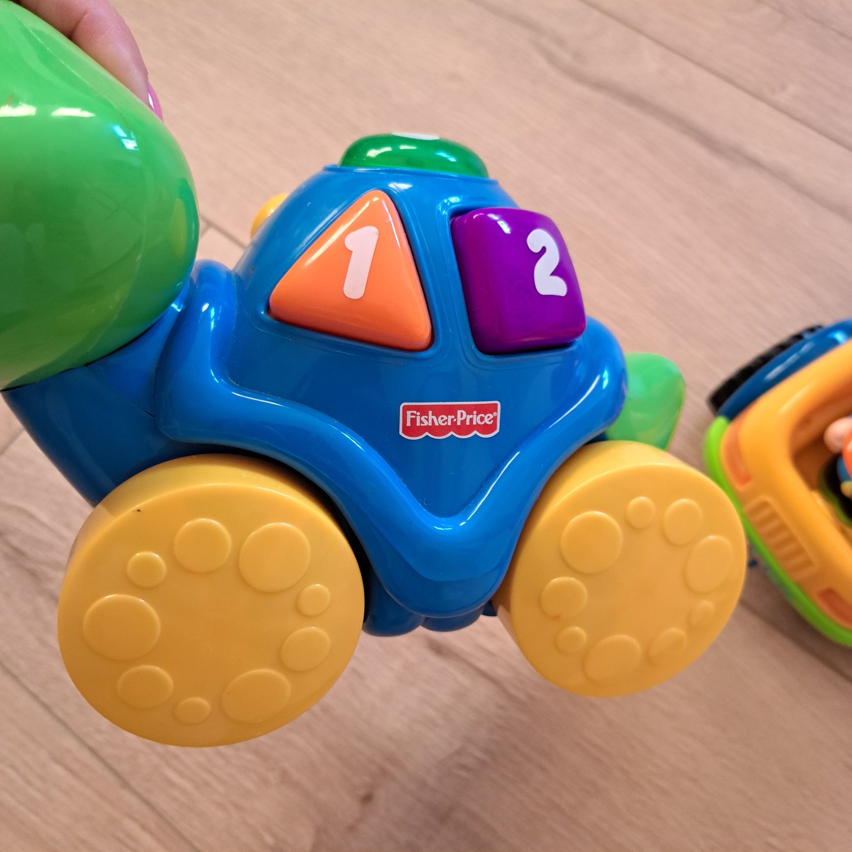 Śpiewajace zabawki 1x fisher price i 1x  dump car sorter