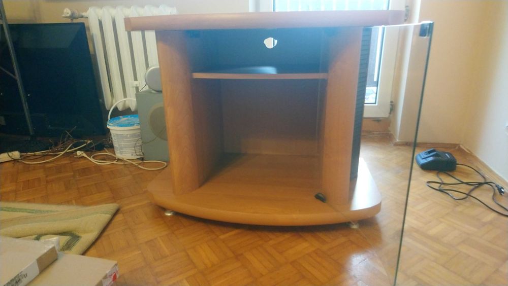 Szafka RTV do salonu w kolorze jasnego drewna ze szklaną witryną.