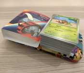 Pack Cartas Pokémon + Charizard tin + mini portfólio