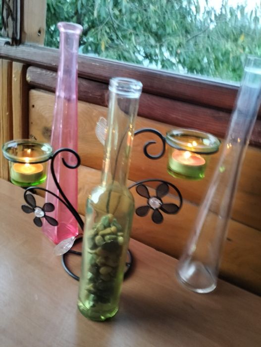 Świecznik , różowa butelka z kamieniami