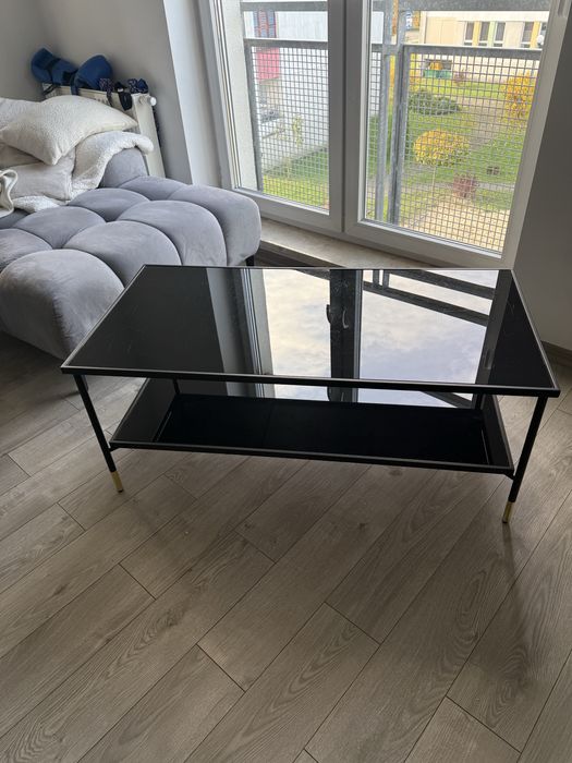 Czarna szklana ława ze złotymi dodatkami