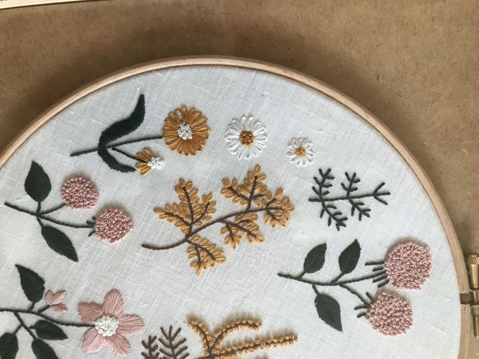 Quadros bordados à mão com motivos de flores.