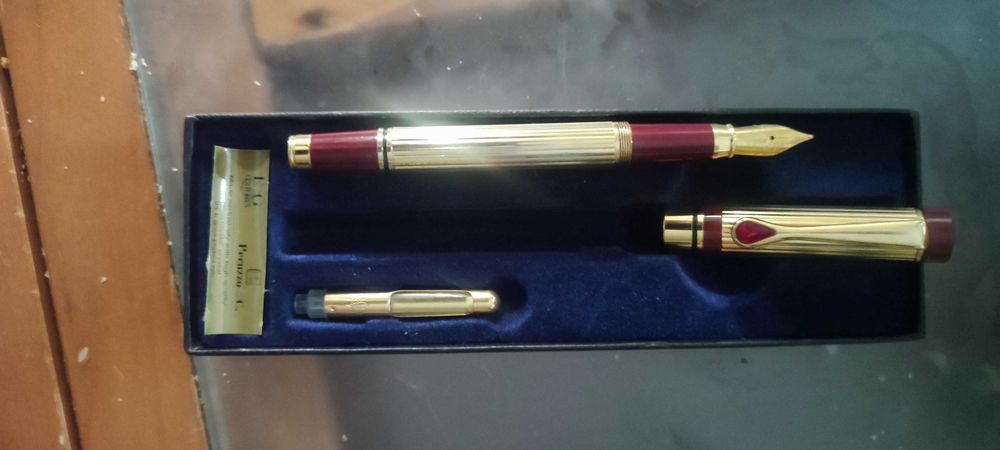 caneta-tinteiro Peruzzo em dourado e bordeaux.