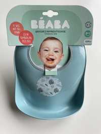 Jasnoniebieski wiązany śliniak dla niemowląt z kieszonką BEABA