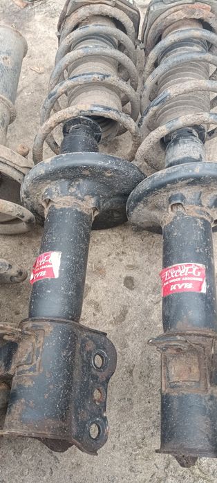 Стойки передние и задние Мазда 323 в сборе