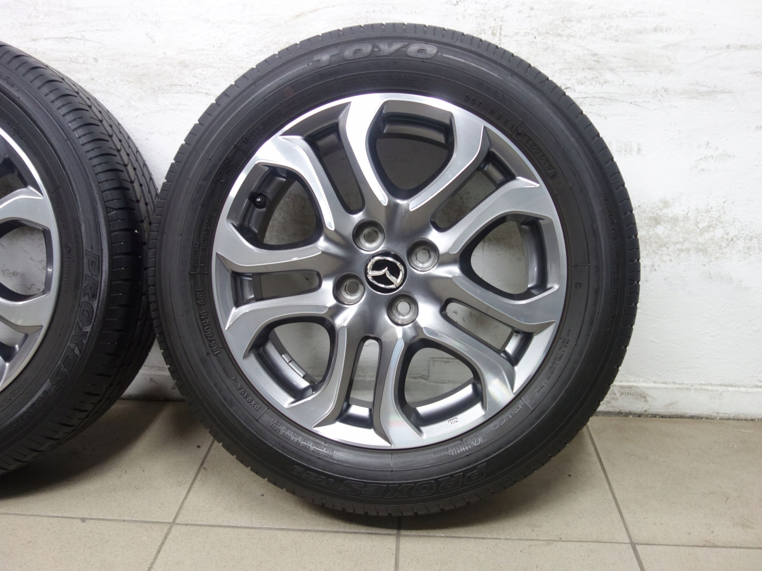 185/60R16 4x100 Koła letnie Mazda 2 OE opony Toyo Proxes R39 Jak nowe