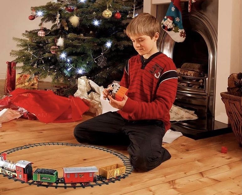 Дитяча різдвяна залізниця поїзд що світиться та гуде святкова іграшка