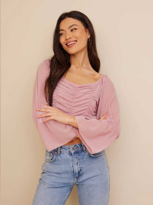 Рожевий топ з об'ємними рукавами