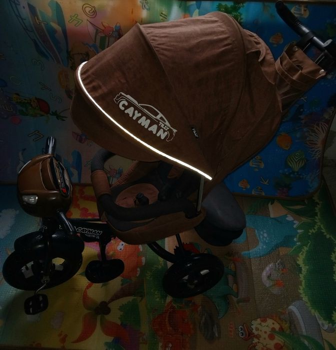 Продам детский музыкальный  велосипед-коляска Cayman.