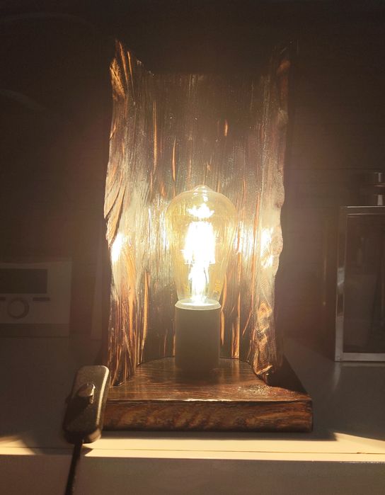 Lampka nocna drewniana,  opalona z ozdobną żarówką.