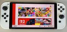 Nintendo Switch OLED biała + kontroler Nin. Switch Pro + walizka +etui
