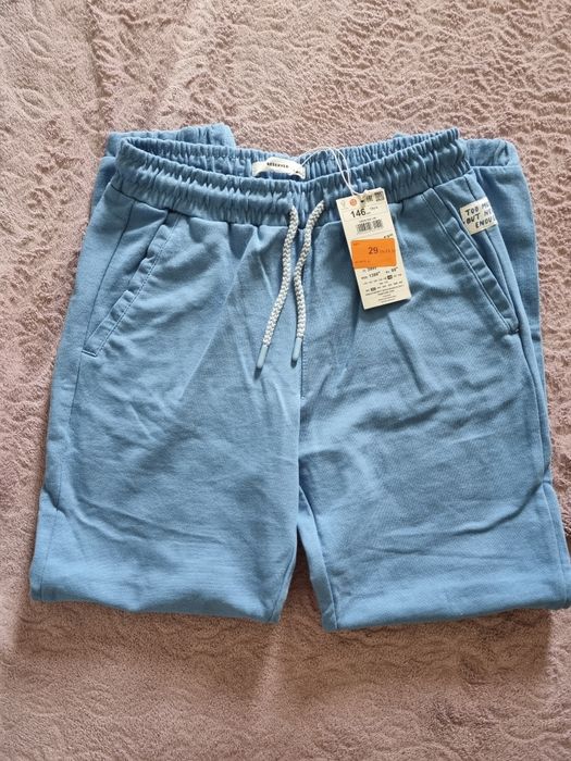 Nowe, niebieskie dresy Reserved, r. 146