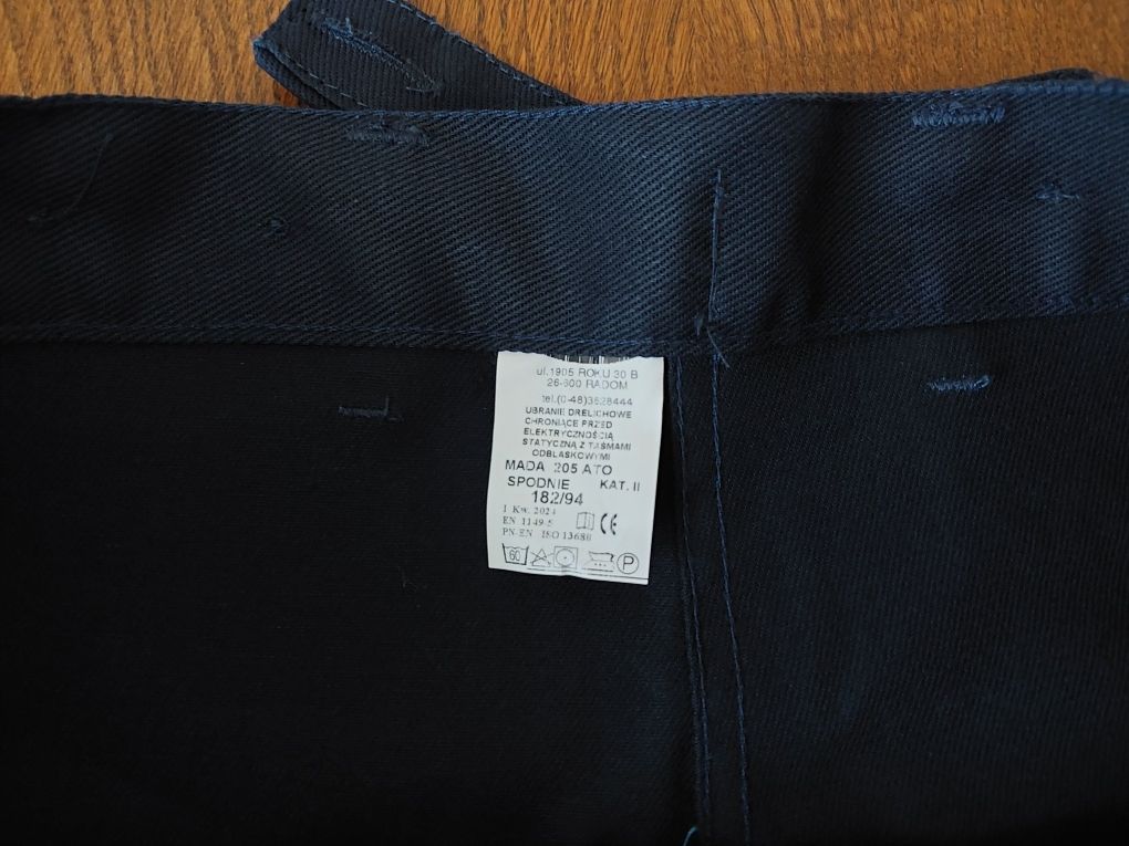 Nowe spodnie robocze z odblaskami rozmiar 182/94 z regulacją pasa