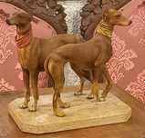 Escultura de casal de galgos em ceramica sobre pedra