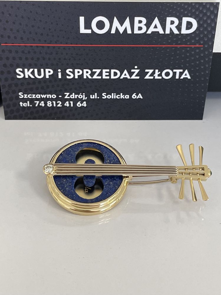 Złota broszka z brylantem