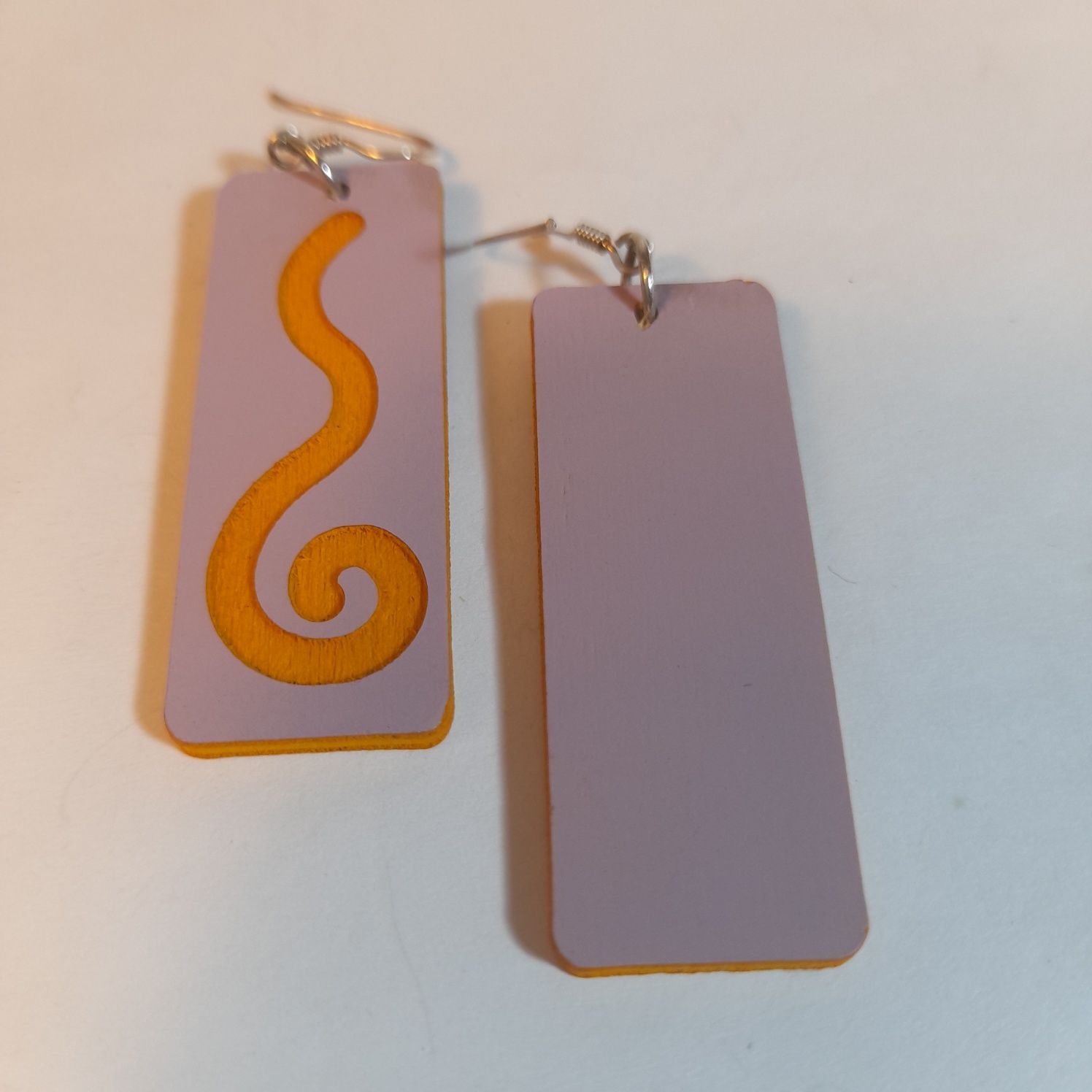 Wooden earrings with spiral design.