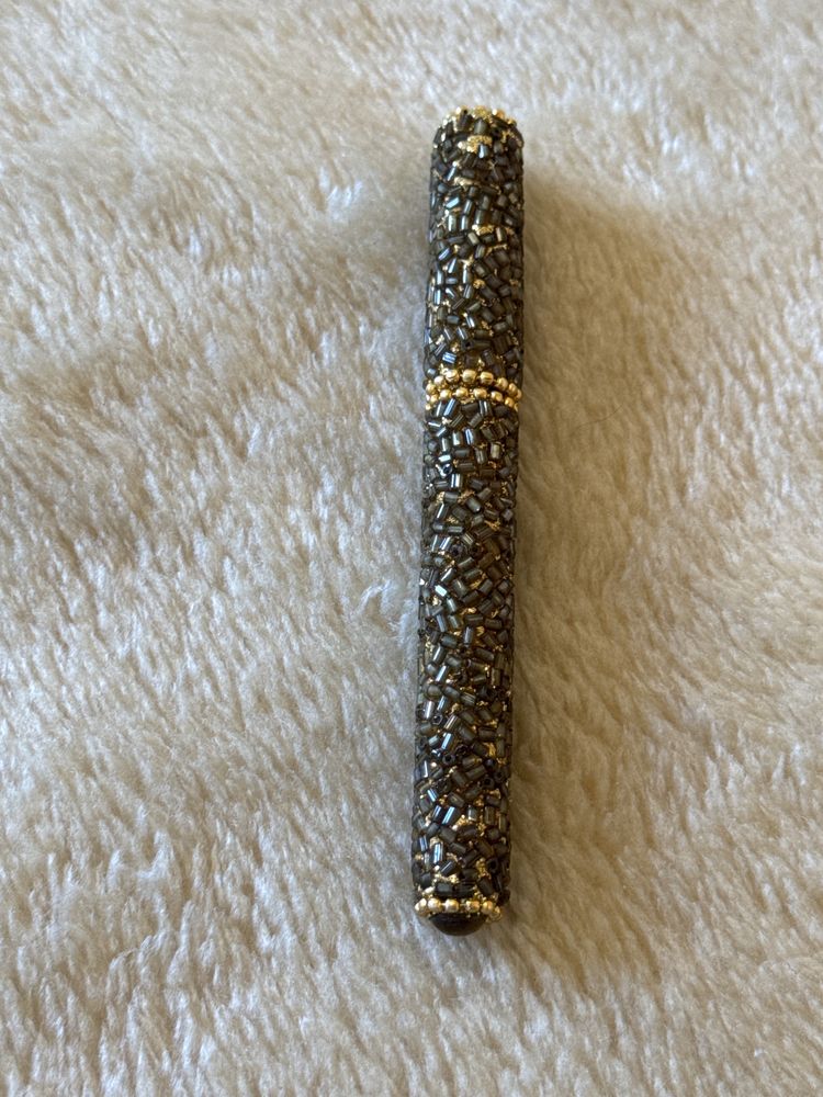 Caneta dourada em missangas