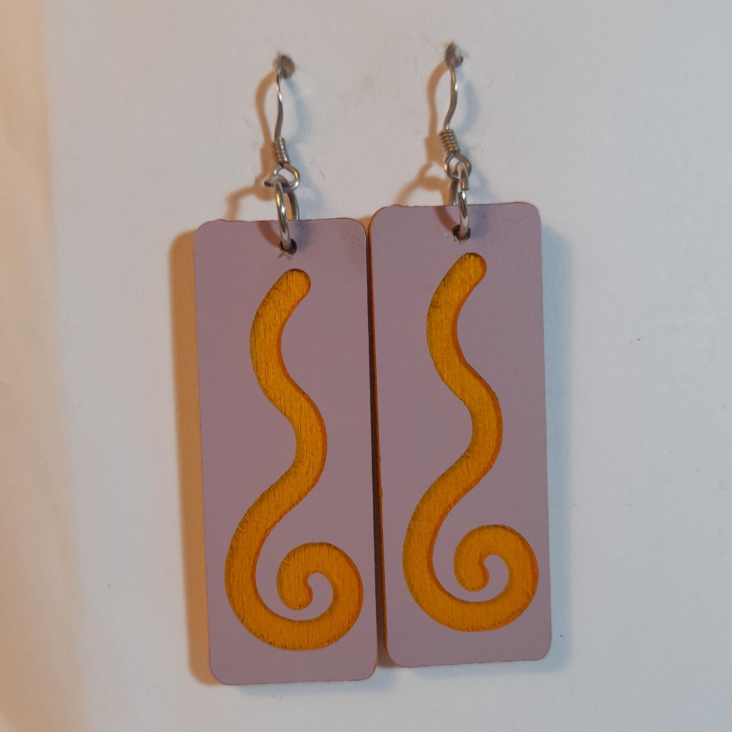 Wooden earrings with spiral design.