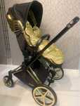 Cybex by Jeremy Scott - black gold wings