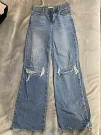 Szerokie jeansy z dziurami stradivarius
