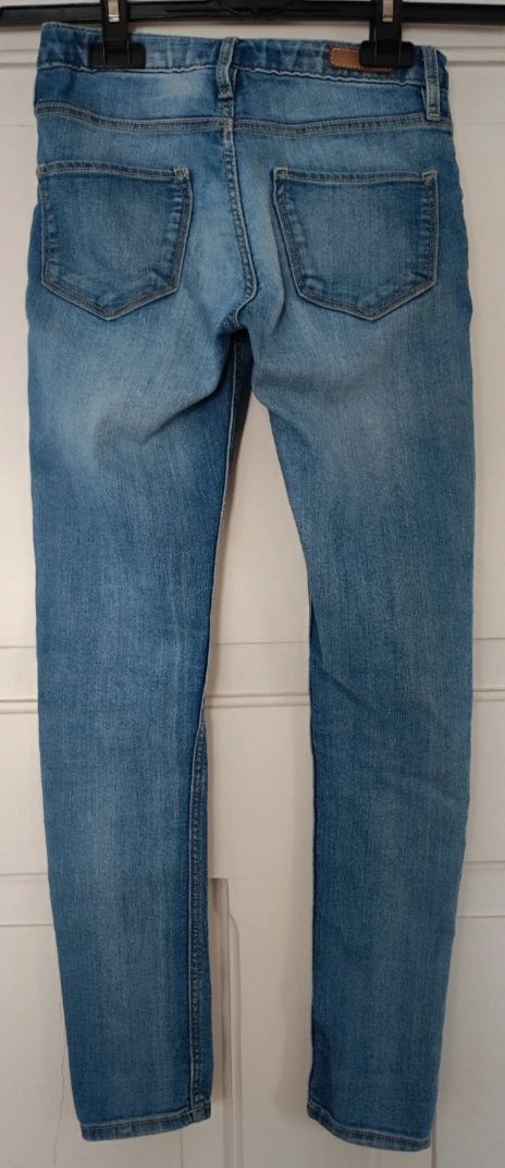 Spodnie jeansy jasne dziury na kolanach skinny H&M r.140 9-10 lat