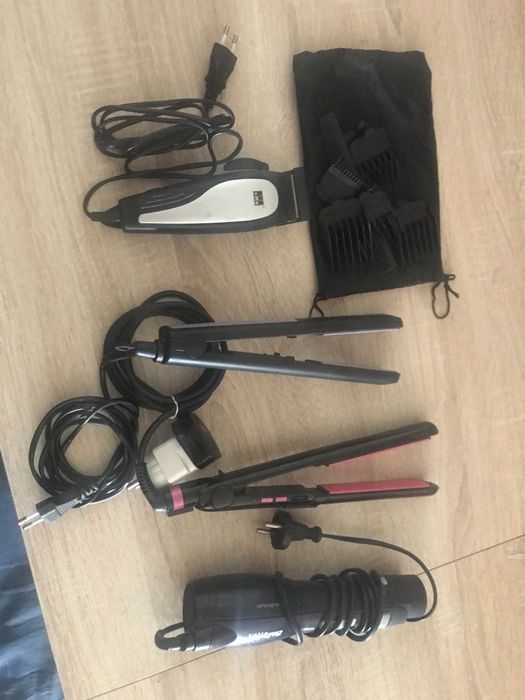 dois alisadores um secador e uma maquina de cortar cabelo usados