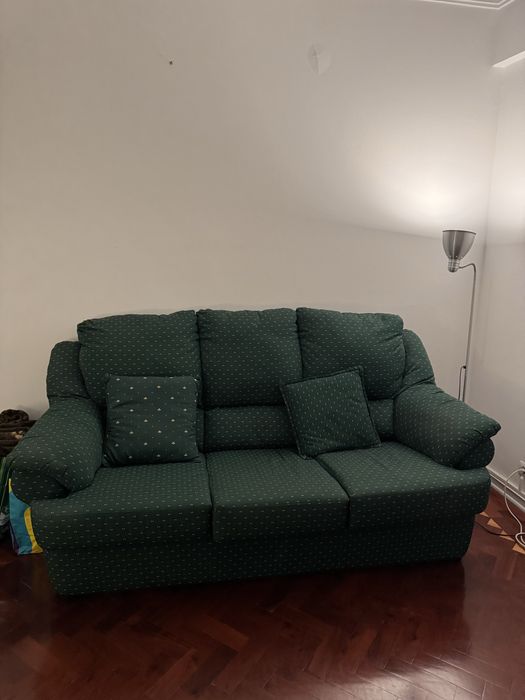 Sofá verde com almofadas e detalhes amarelos