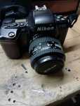 Máquinas fotográficas Nikon e Olympia