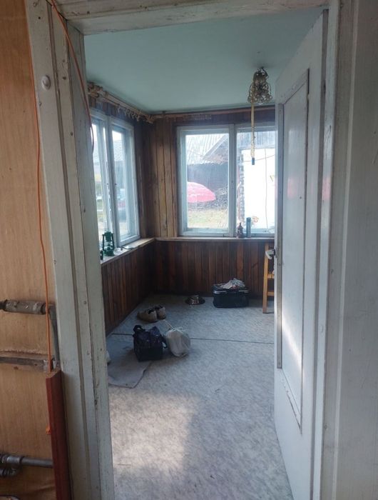 Dom drewniany z murowaną przybudowka.